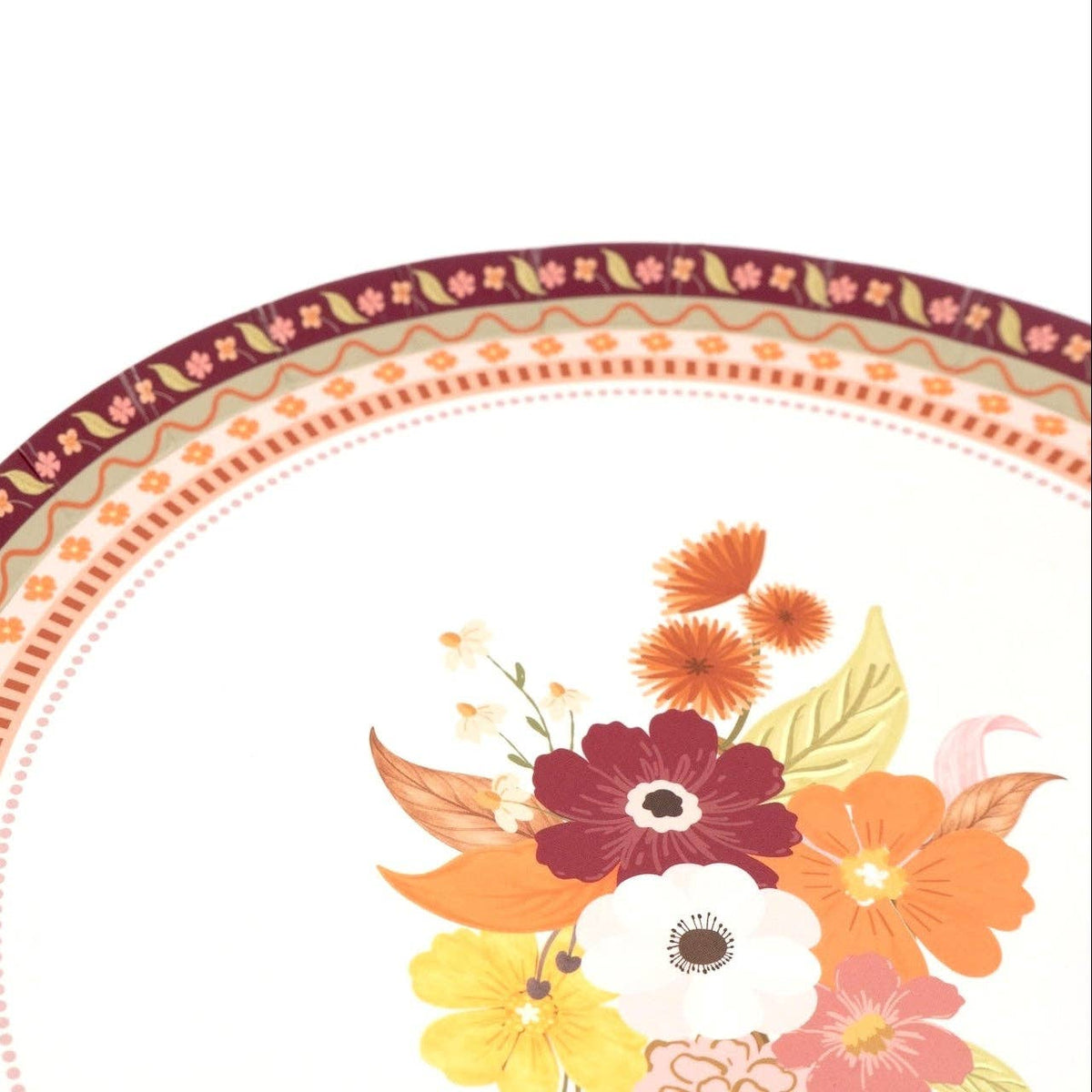 Angled view of the fall dessert plate showing the bouquet off-center with the patterned border.