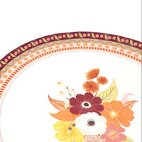 Angled view of the fall dessert plate showing the bouquet off-center with the patterned border.