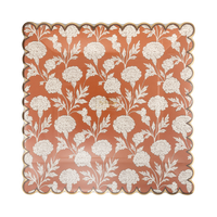 Clear packaging close-up of the cream floral print and copper foil scalloped edge, front view.