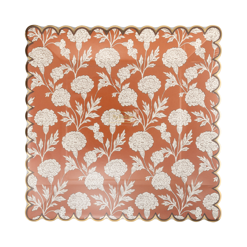 Clear packaging close-up of the cream floral print and copper foil scalloped edge, front view.