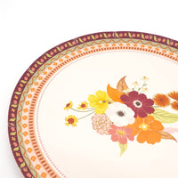 Close-up of the fall floral dessert plate showing the autumn bouquet detail — burgundy, orange, and yellow blooms.