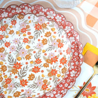 Close-up of a cream fall floral dessert plate stacked on a larger rust floral plate