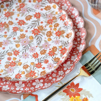 Cream retro floral plate stacked on the rust floral plate showing both designs and the scalloped edges