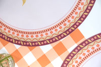 Close-up of the fall floral placemat border showing the intricate patterned detail with part of the gingham runner.