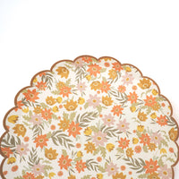 Partial view of a fall floral dessert plate on a white background showing the allover print