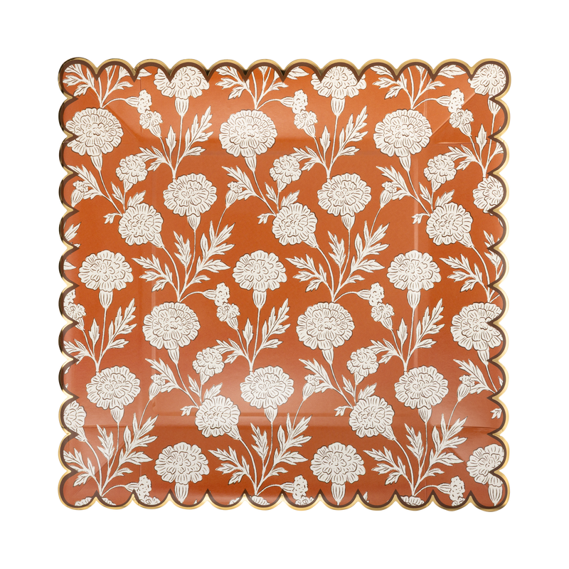 Orange square paper plate with cream florals and a copper foil scalloped edge, front view.