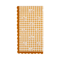 Fall gingham dinner napkin in orange and cream block-print with scattered floral accents and an orange wavy edge, overhead flat-lay.