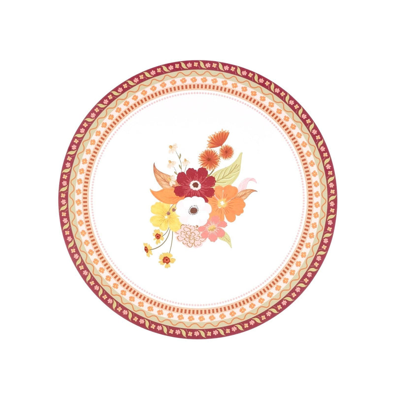 Cream round fall placemat with a central autumn floral bouquet in burgundy, orange, rust, and gold, framed by an intricate patterned border, overhead view on white background.