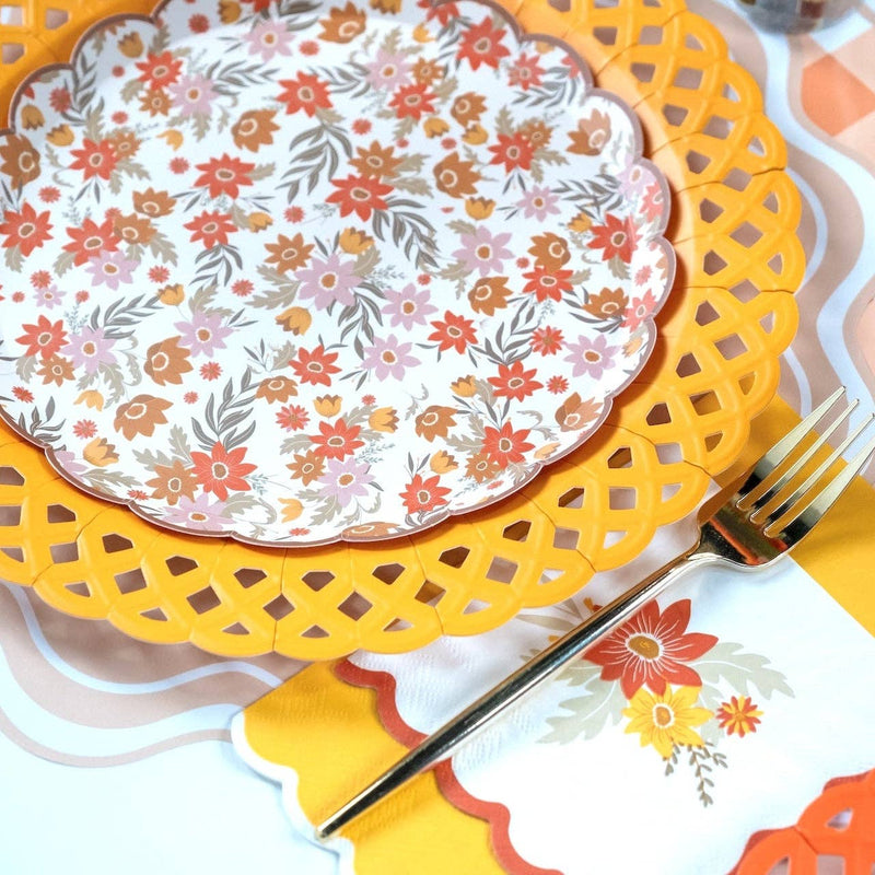 Styled fall place setting showing the yellow basketweave plate as a charger under a floral plate with a burgundy napkin and gingham runner.