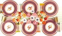 Overhead fall table showing the floral dessert plates with burgundy chargers, gold flatware, orange florals, and a striped runner.