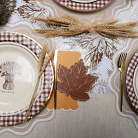 close up fall place setting with scalloped paper placemat and autumn décor
