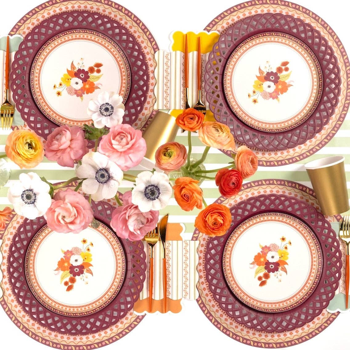 Overhead fall tablescape showing the harvest floral napkins with floral salad plates, burgundy chargers, and autumn florals.