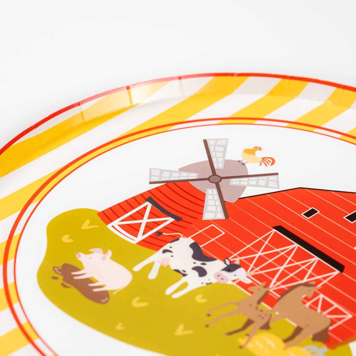 Close-up of red barn plate with windmill and farm animals—perfect for a farm birthday party.