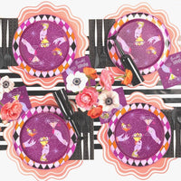 Styled feminine Halloween table — witch hat dessert plates on black chargers, pink roses, striped runner, and the black guest towels alongside gold flatware.