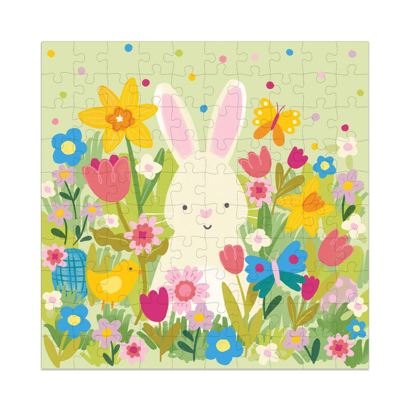 The completed 100-piece Easter garden puzzle showing a cute white bunny surrounded by spring flowers, butterflies, and a yellow bird.
