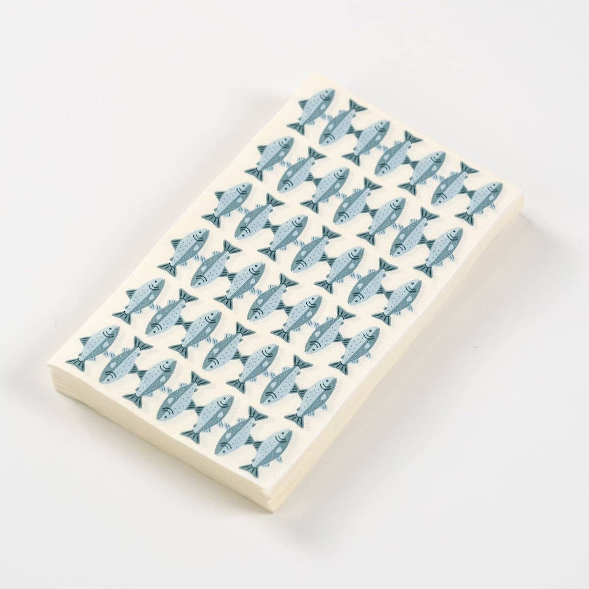 Fish print paper guest towel folded, showing rows of blue trout on cream, on a white background.