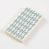 Fish print paper guest towel folded, showing rows of blue trout on cream, on a white background.