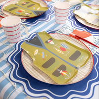 Bobber napkin beside a vest plate, fish print napkin, and red-handled fork on a striped table cover.