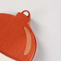 Close-up of the top loop and orange dome of a fishing bobber shaped napkin.