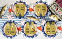 Overhead fishing party table with vest plates, bobber napkins, fish napkins, and a tackle box.