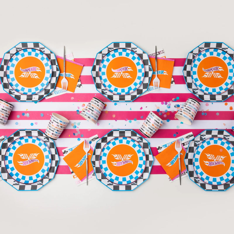 Overhead flat lay showing a table setup featuring the blue checkered plates layered over octagonal plates on a striped runner.