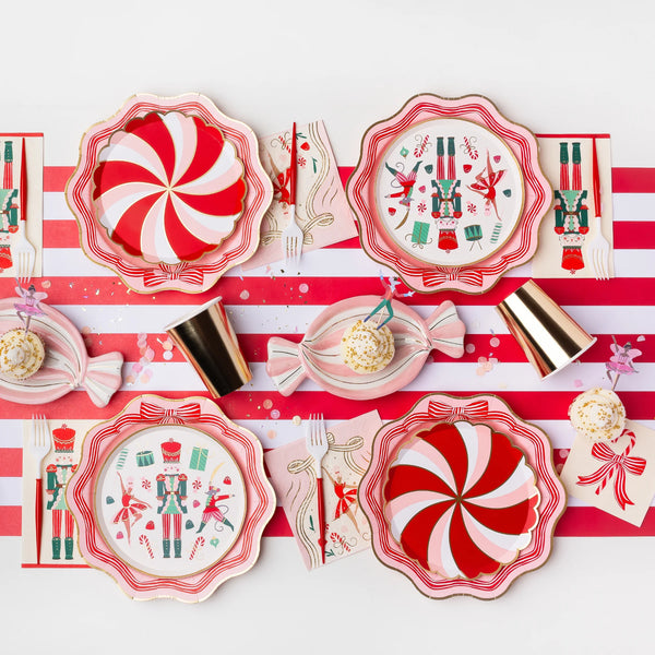 Flat lay of a holiday table featuring the nutcracker napkins, matching plates, and gold cups.