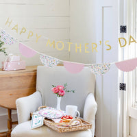 Floral border napkin styled with Mother's Day brunch and banner