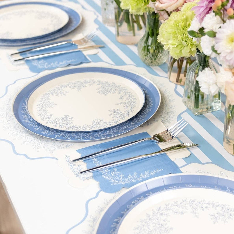 Blue floral paper guest towels arranged on a spring table setting with flowers.
