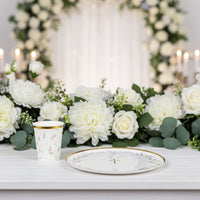 floral party cup with plate and floral backdrop setup
