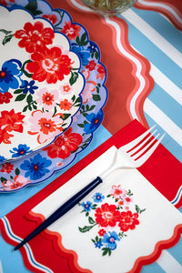 A Floral Patriotic Plate layered with a matching floral napkin and white and blue fork for a Coastal Americana Dinner Party.