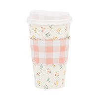 A single 16oz paper coffee cup featuring a wildflower print and a scalloped pink-and-white gingham cardboard heat sleeve on a white background.