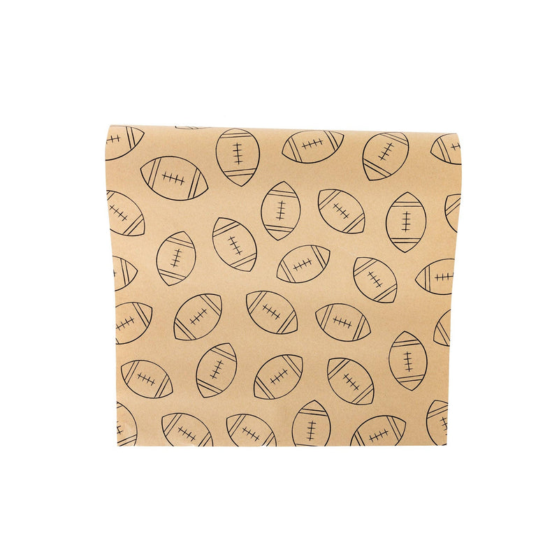 Kraft paper table runner printed with hand-drawn black footballs, partially unrolled