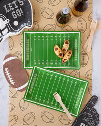 Overhead game day snack table with the football runner, field trays, helmet plate, and foam finger napkin