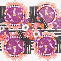 Symmetrical overhead view of four Midnight Spirits place settings arranged with pink scalloped chargers on a black striped runner.