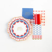 Happy 4th of July Plates styled with matching napkins and cups for a complete table setting.
