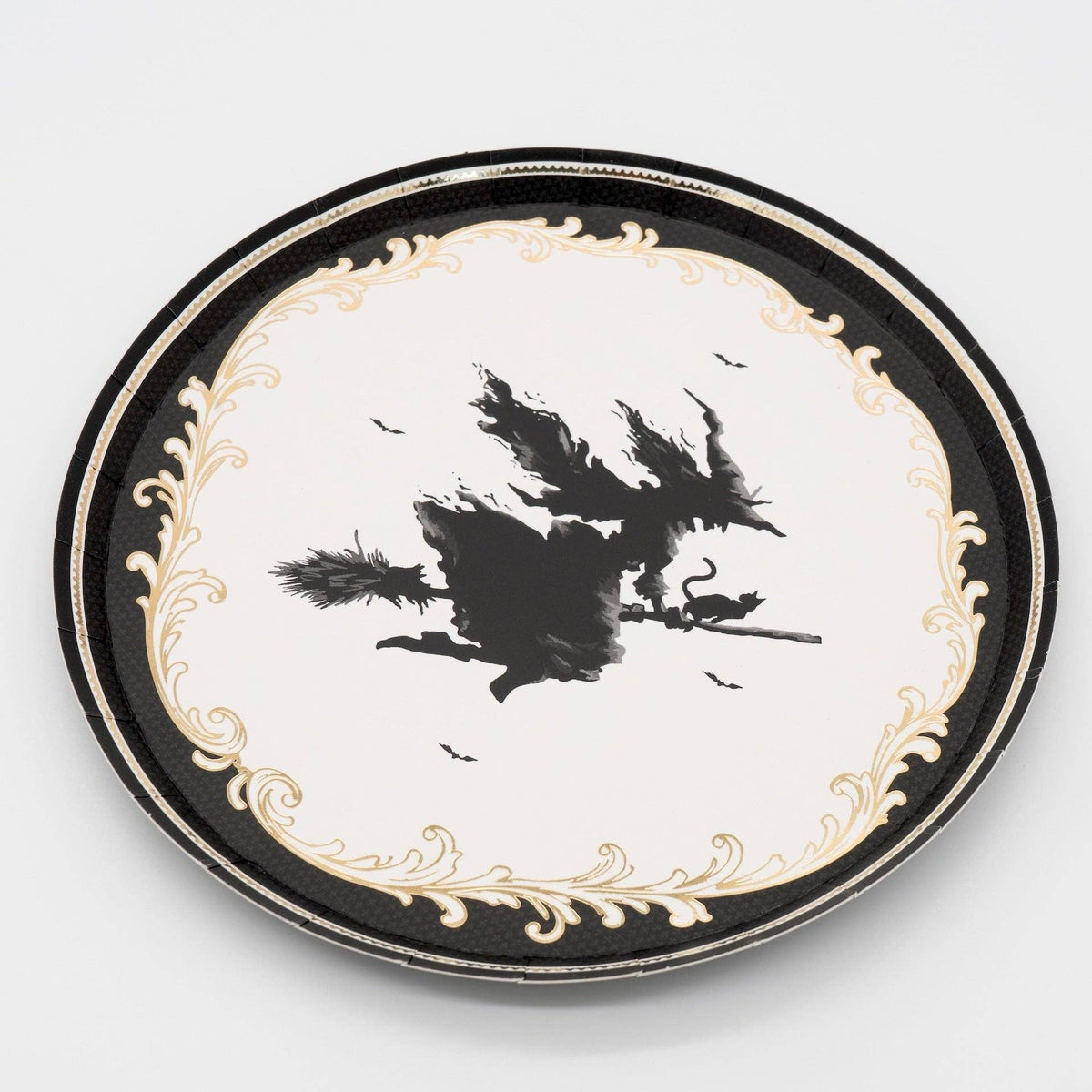 Front-facing studio view of the 7 inch vintage witch paper dessert plate emphasizing its crisp white center and intricate border.
