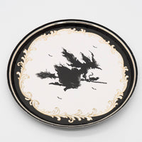 Front-facing studio view of the 7 inch vintage witch paper dessert plate emphasizing its crisp white center and intricate border.