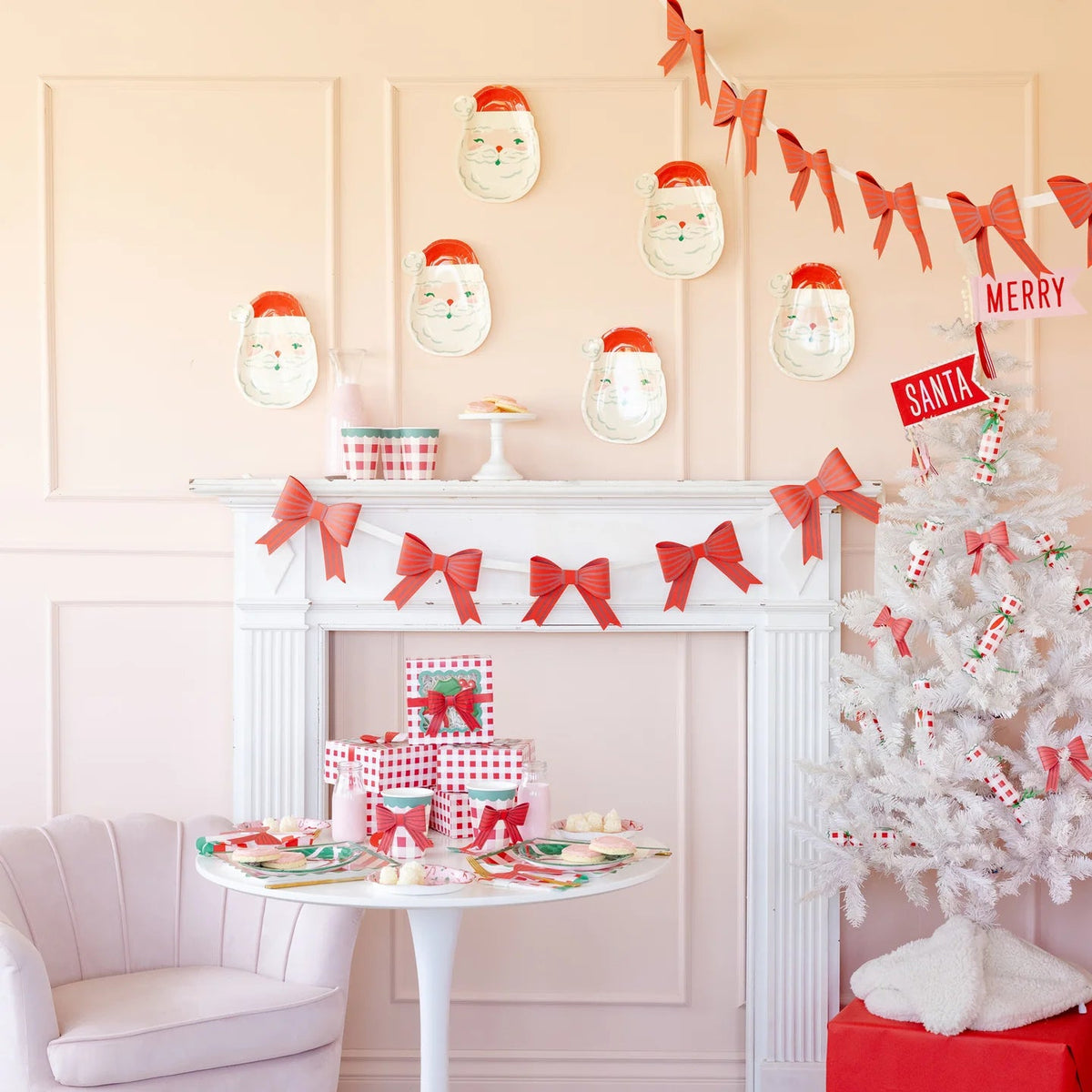 Full room display of a holiday setting featuring the Christmas party plates on a table and Santa plate cutouts hung on the wall.