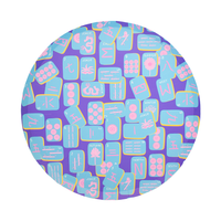 Round dinner plate with colorful mahjong tile pattern on purple background