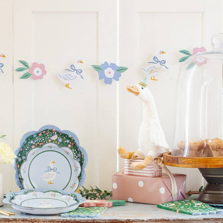Garden goose banner displayed above a spring party table with Easter decor