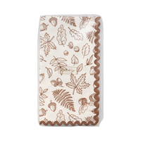 Paper napkin with autumn leaf pattern on transparent packaging, front view.