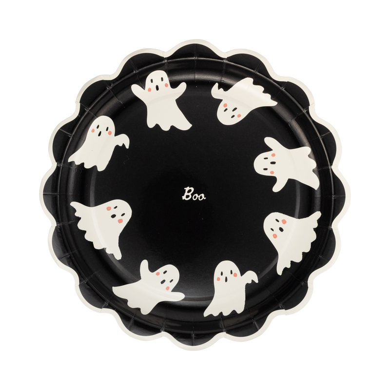 Scalloped black paper plate with cream ghosts spelling "BOO," front view.