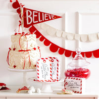 Close-up dessert vignette with two tag Christmas cookie boxes bags standing on cake stand