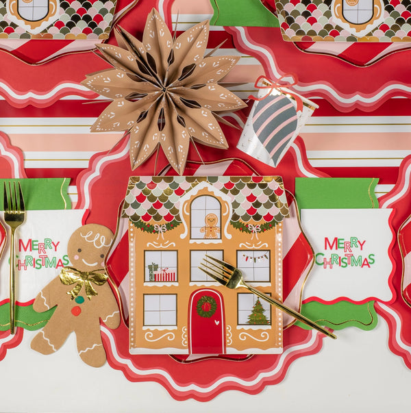 Overhead setting with ‘Merry Christmas’ napkins and gingerbread accent.