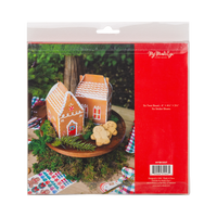 Back of gingerbread house treat box package showing 2 boxes on a cake stand with gingerbread cookies