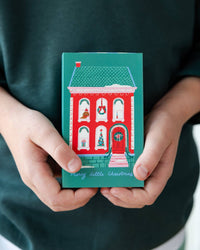 Child holding gingerbread man treat box in green and blue stripes