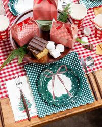 Gingham place setting with a wreath plate layered on a gingham dinner plate.
