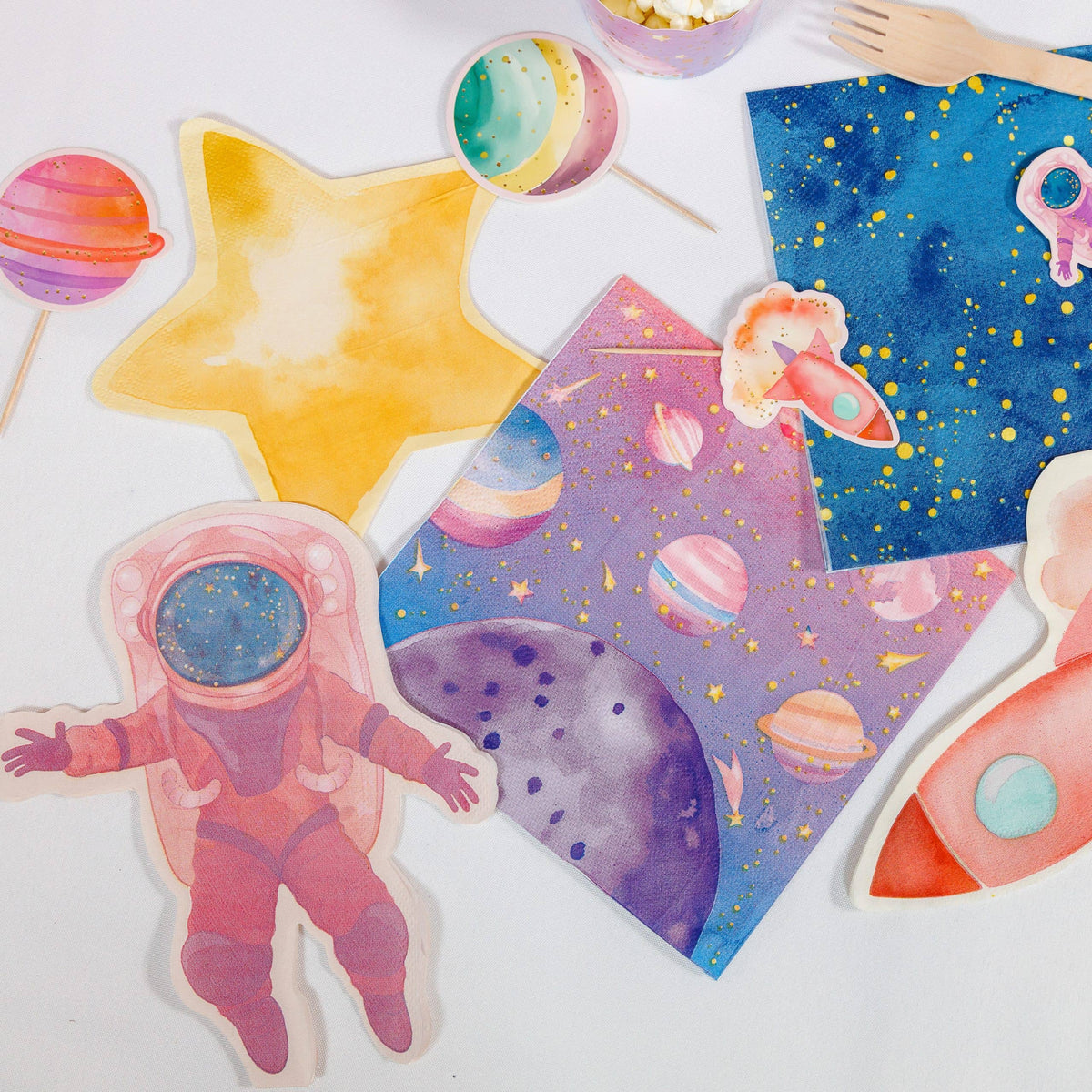 Girl astronaut napkins around a pink planet plate and navy galaxy plate
