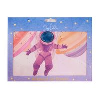 Girl astronaut space banner in Joy Ladder packaging showing the pink astronaut and pastel planets through the window.