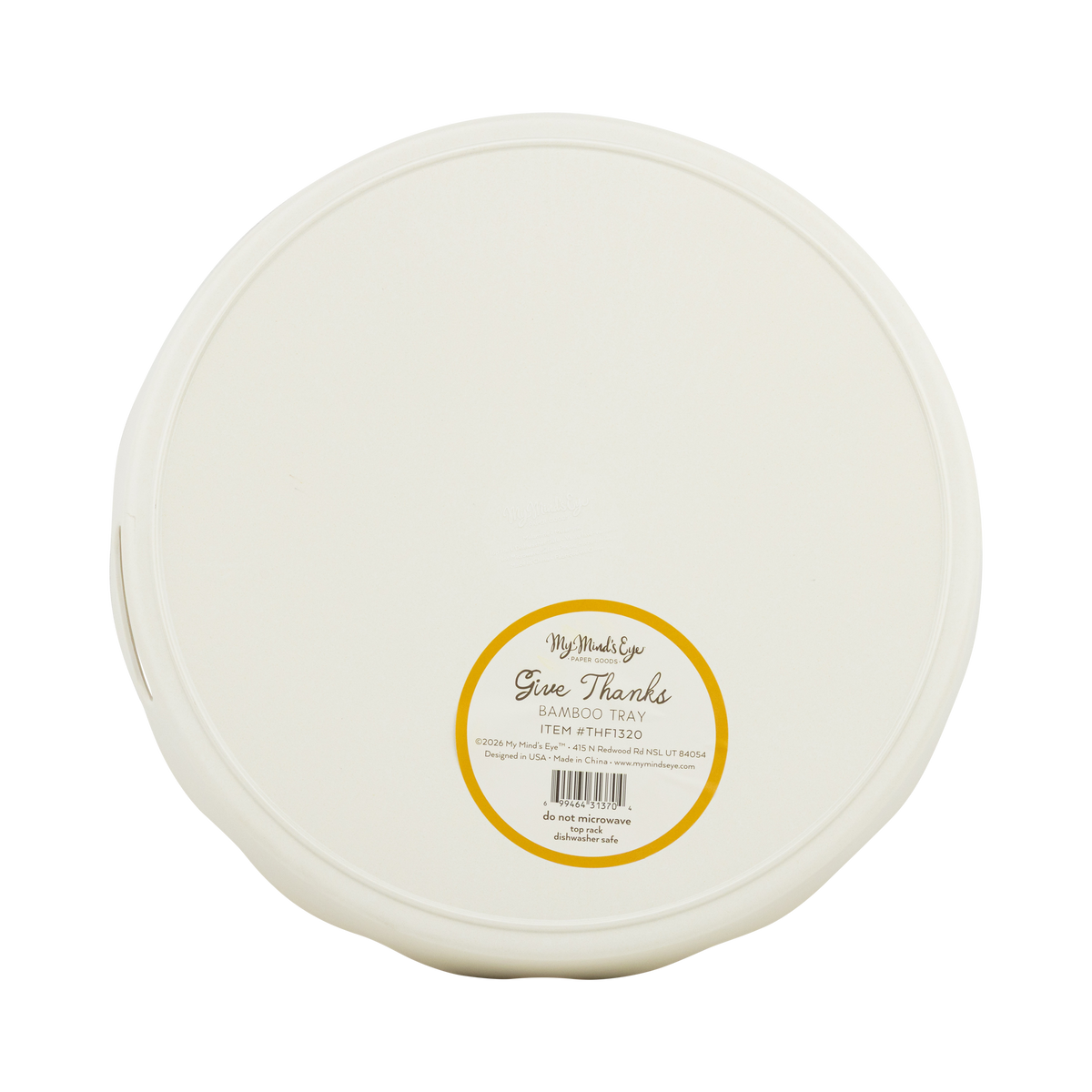 Round white bamboo tray with a yellow label on a transparent packaging, back view